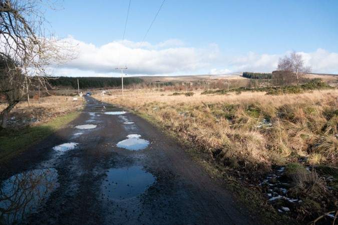 Road with 'parking' at the far end of photo.